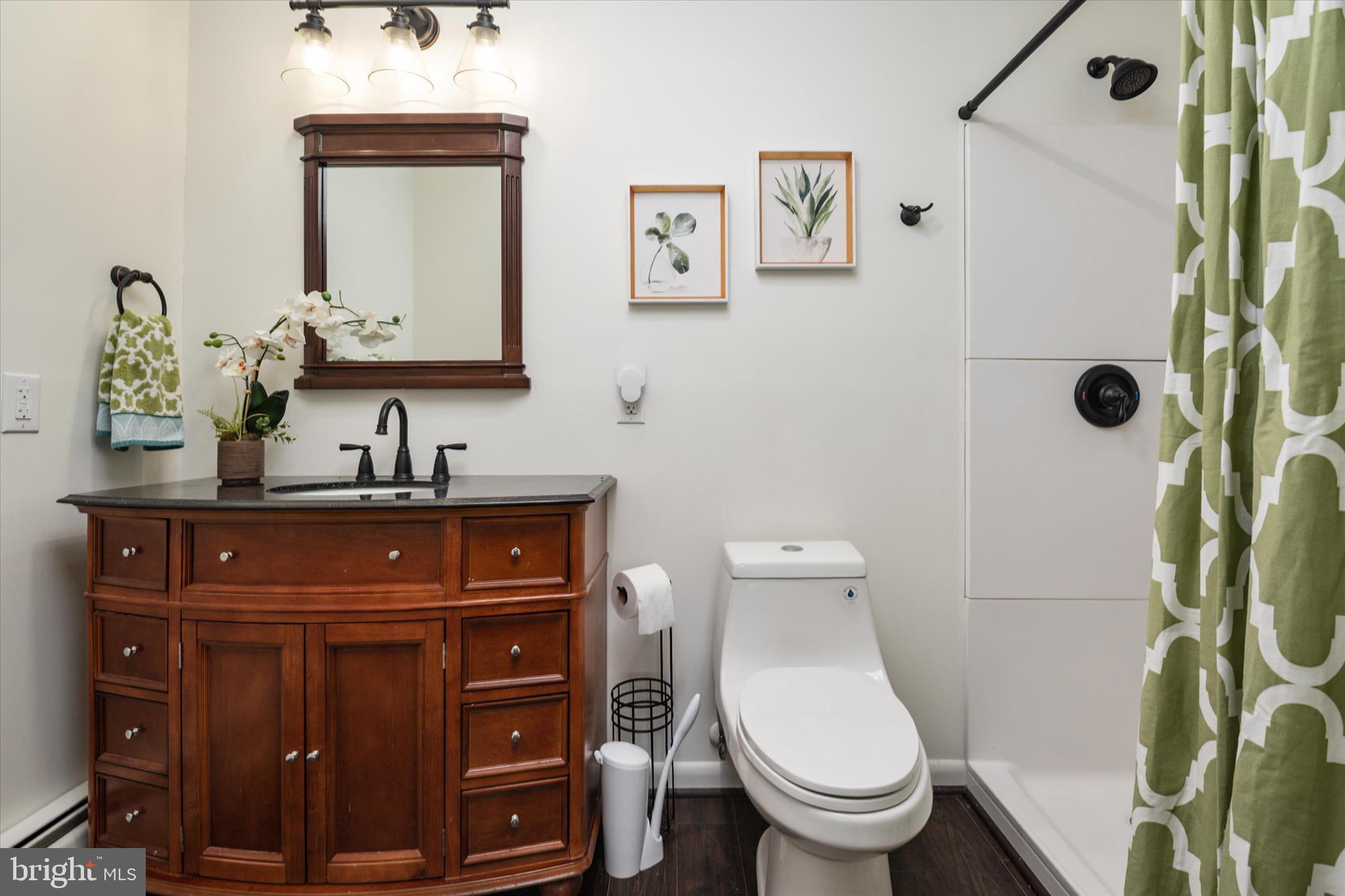 4305 Langrell Road Preston, MD 21655 - Photo 20 of 36 a bathroom with a toilet sink and mirror