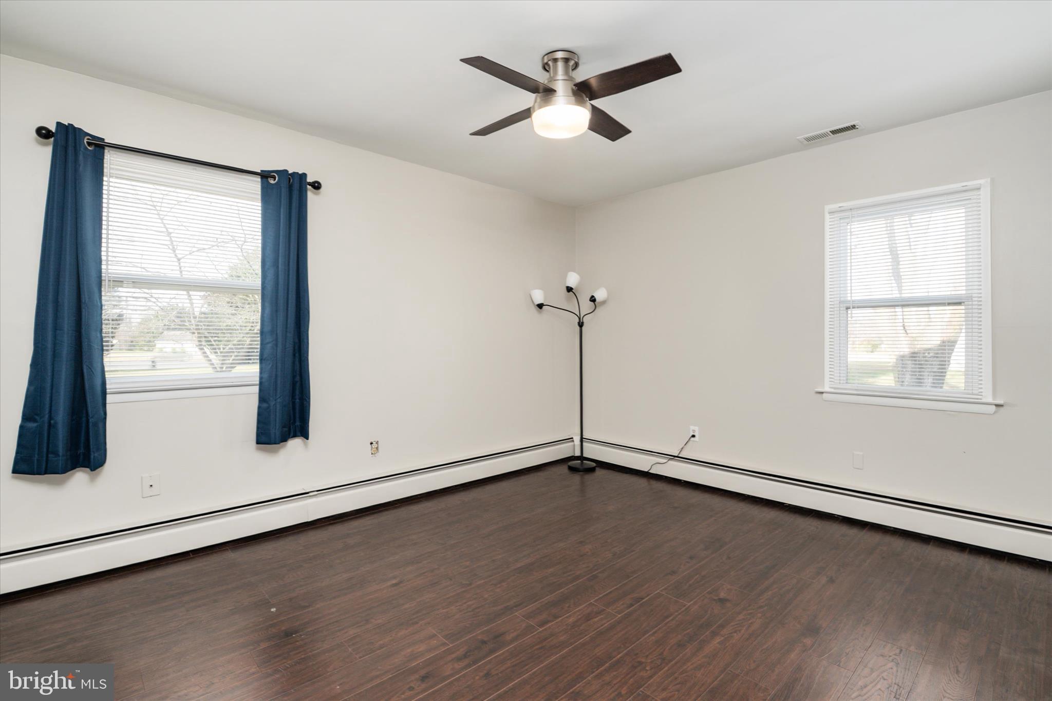 4305 Langrell Road Preston, MD 21655 - Photo 21 of 36 an empty room with wooden floor and windows