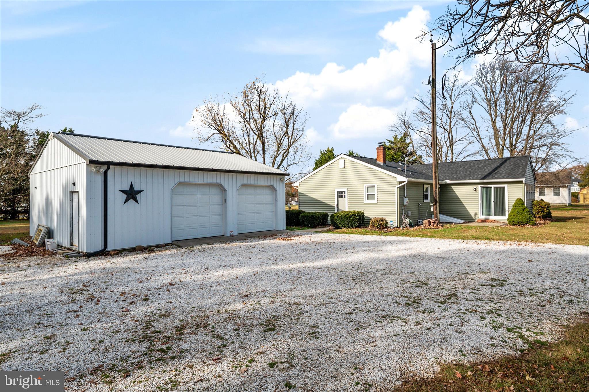 4305 Langrell Road Preston, MD 21655 - Photo 27 of 36 a view of large house with a large tree and wooden fence
