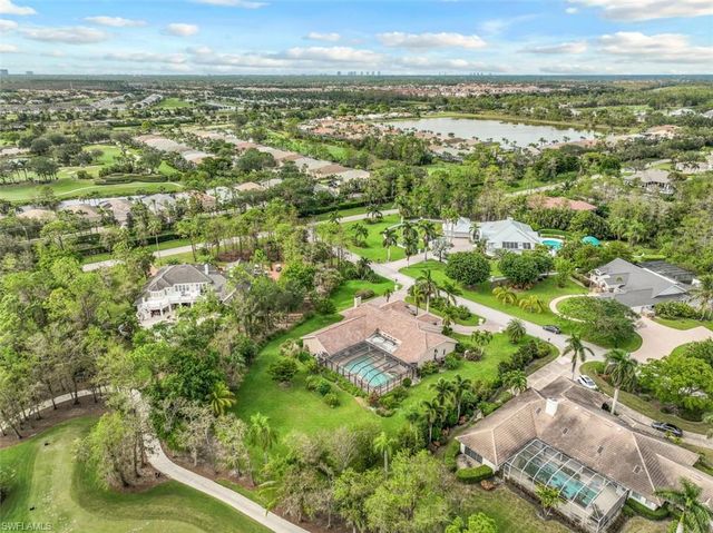 an aerial view of residential building with outdoor space and trees