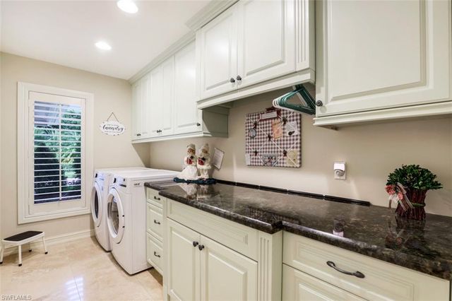 a kitchen with stainless steel appliances granite countertop a sink a stove and cabinets