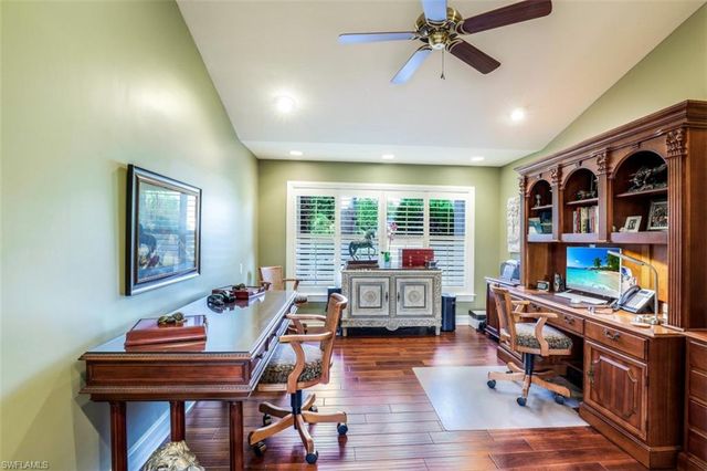 a work room with furniture and a potted plant