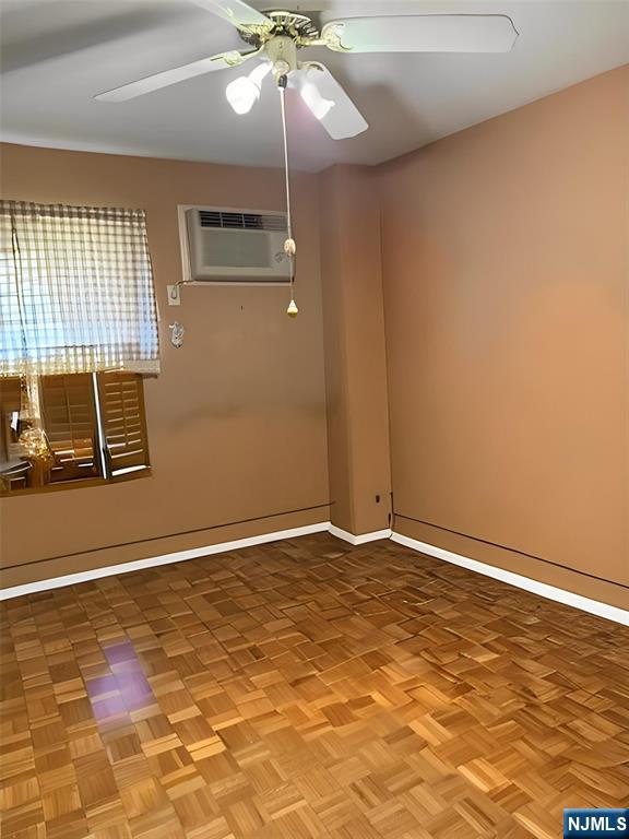 140 Euclid Avenue, Unit 4G Hackensack, NJ 07601 - Photo 12 of 13 an empty room with wooden floor fan and windows