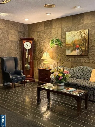 a living room with fireplace furniture and a wooden floor