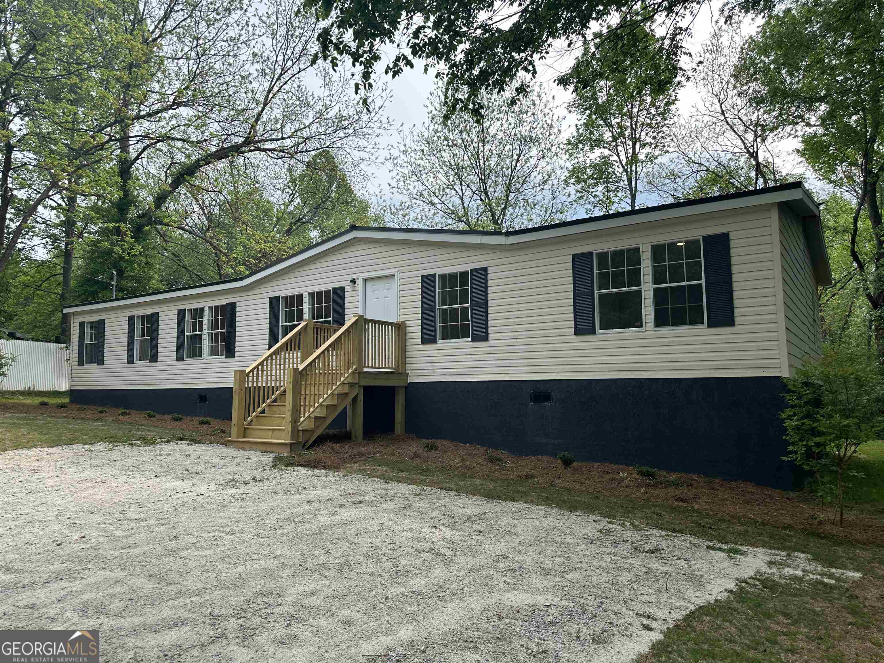 1121 Community Drive Union Point, GA 30669 - Photo 1 of 1 a house that has tree in front of it