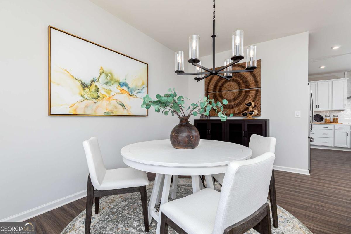 740 Coventry Cv Way Acworth, GA 30102 - Photo 13 of 41 a view of a dining room with furniture and wooden floor