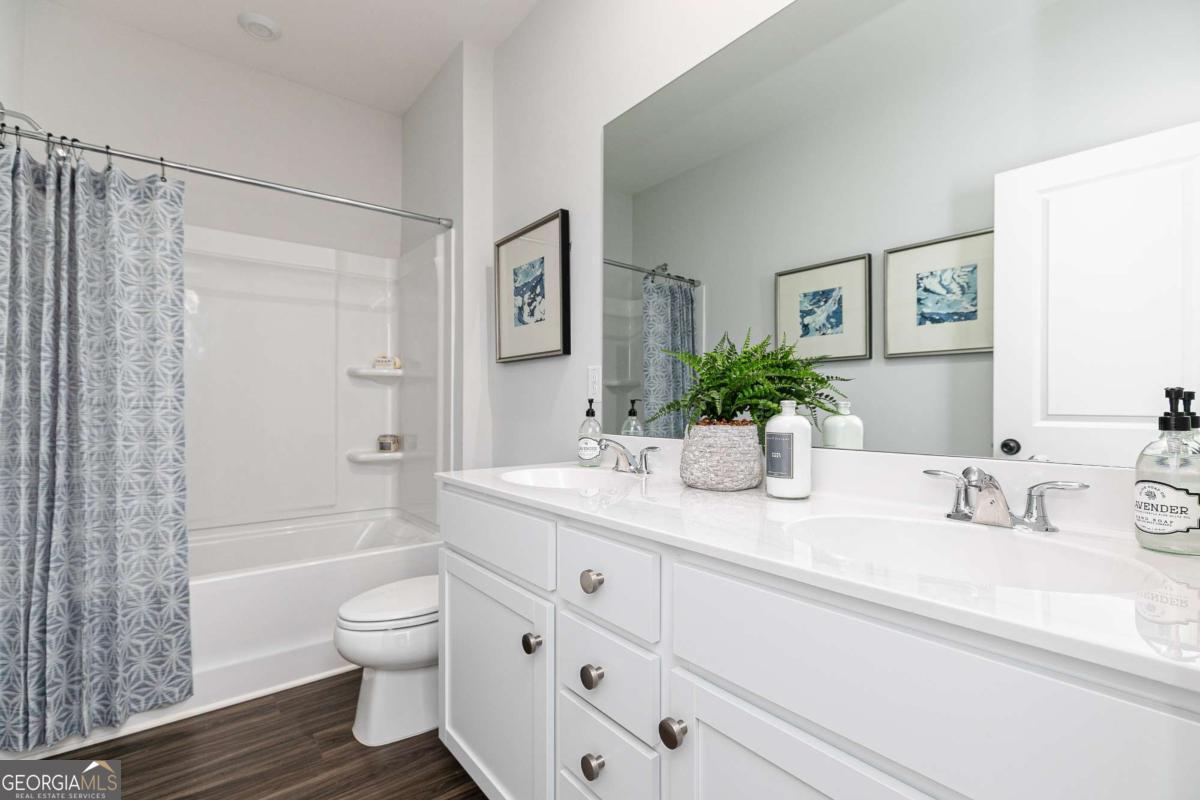 740 Coventry Cv Way Acworth, GA 30102 - Photo 2 of 41 a bathroom with a granite countertop sink a toilet and shower