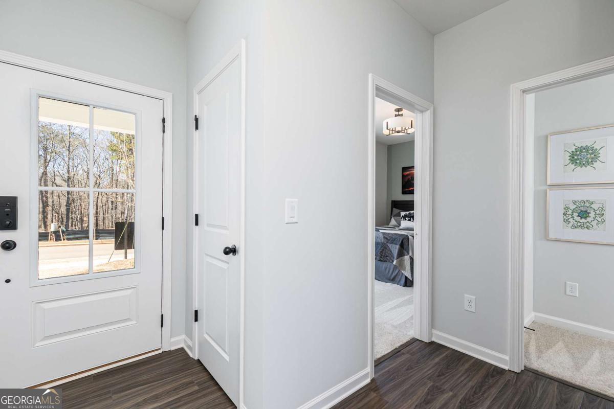 740 Coventry Cv Way Acworth, GA 30102 - Photo 21 of 41 a view of a hallway with wooden floor and closet