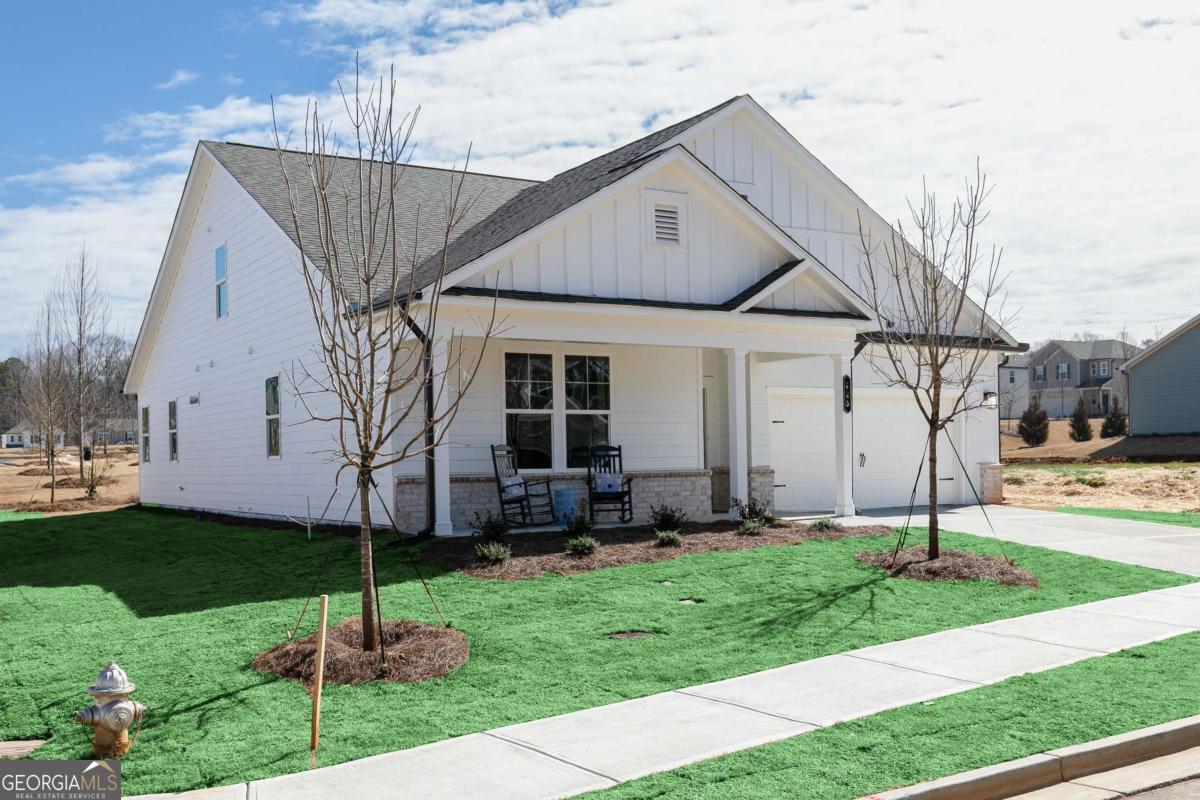 740 Coventry Cv Way Acworth, GA 30102 - Photo 23 of 41 a front view of a house with a garden and plants