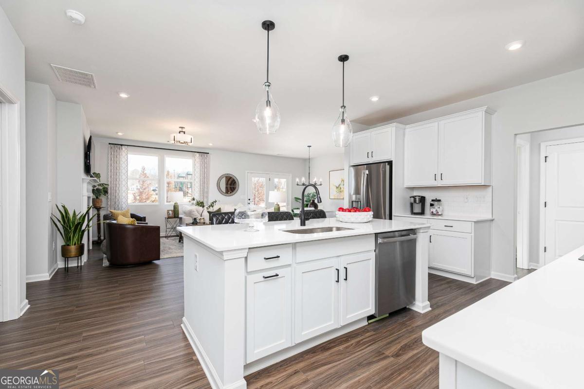 740 Coventry Cv Way Acworth, GA 30102 - Photo 24 of 41 a kitchen with stainless steel appliances kitchen island granite countertop a stove a sink a center island and cabinets