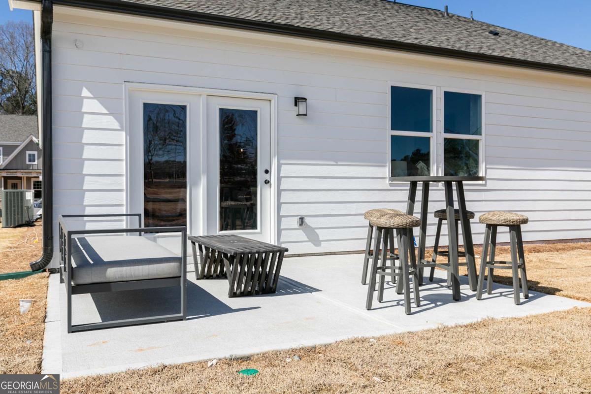 740 Coventry Cv Way Acworth, GA 30102 - Photo 35 of 41 a view of a patio with table and chairs and wooden floor