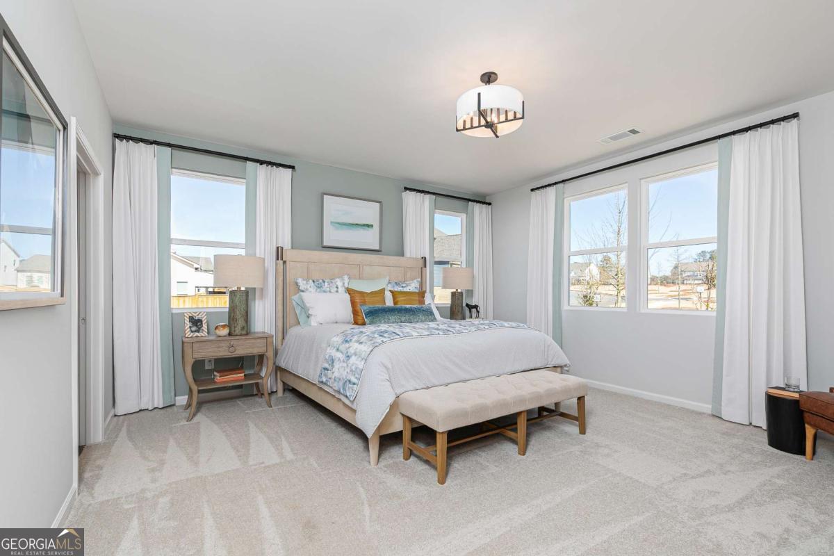 740 Coventry Cv Way Acworth, GA 30102 - Photo 39 of 41 a bedroom with a bed and a chandelier