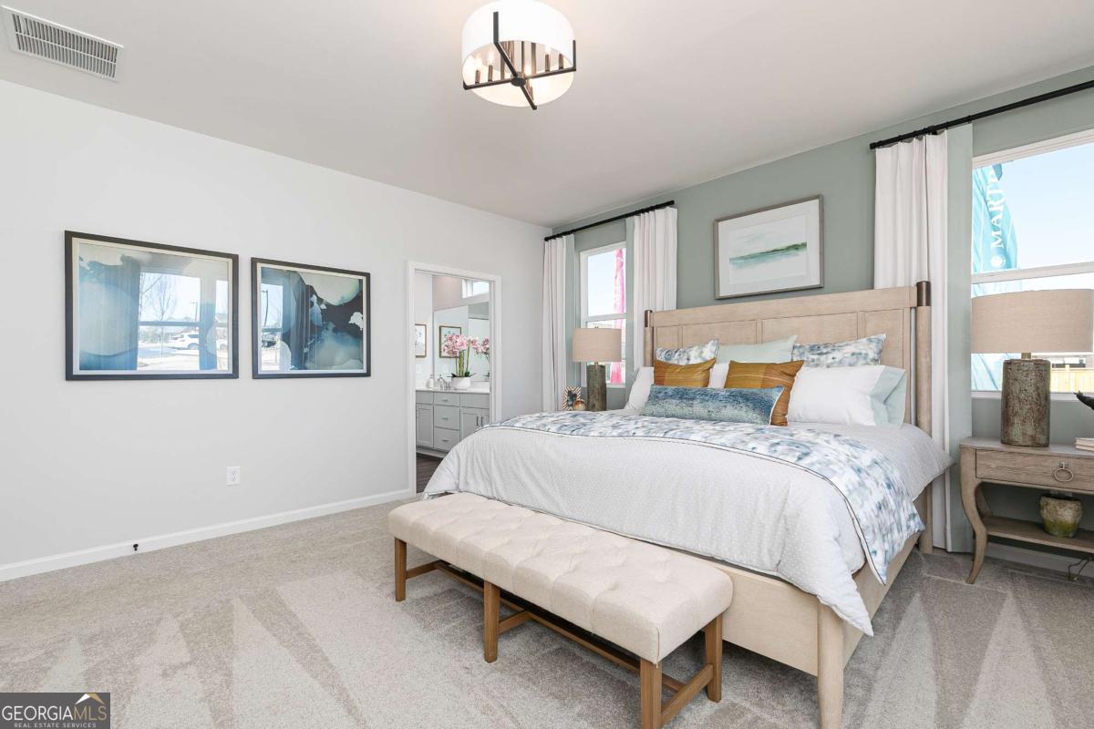 740 Coventry Cv Way Acworth, GA 30102 - Photo 40 of 41 a bedroom with a bed a table and painting