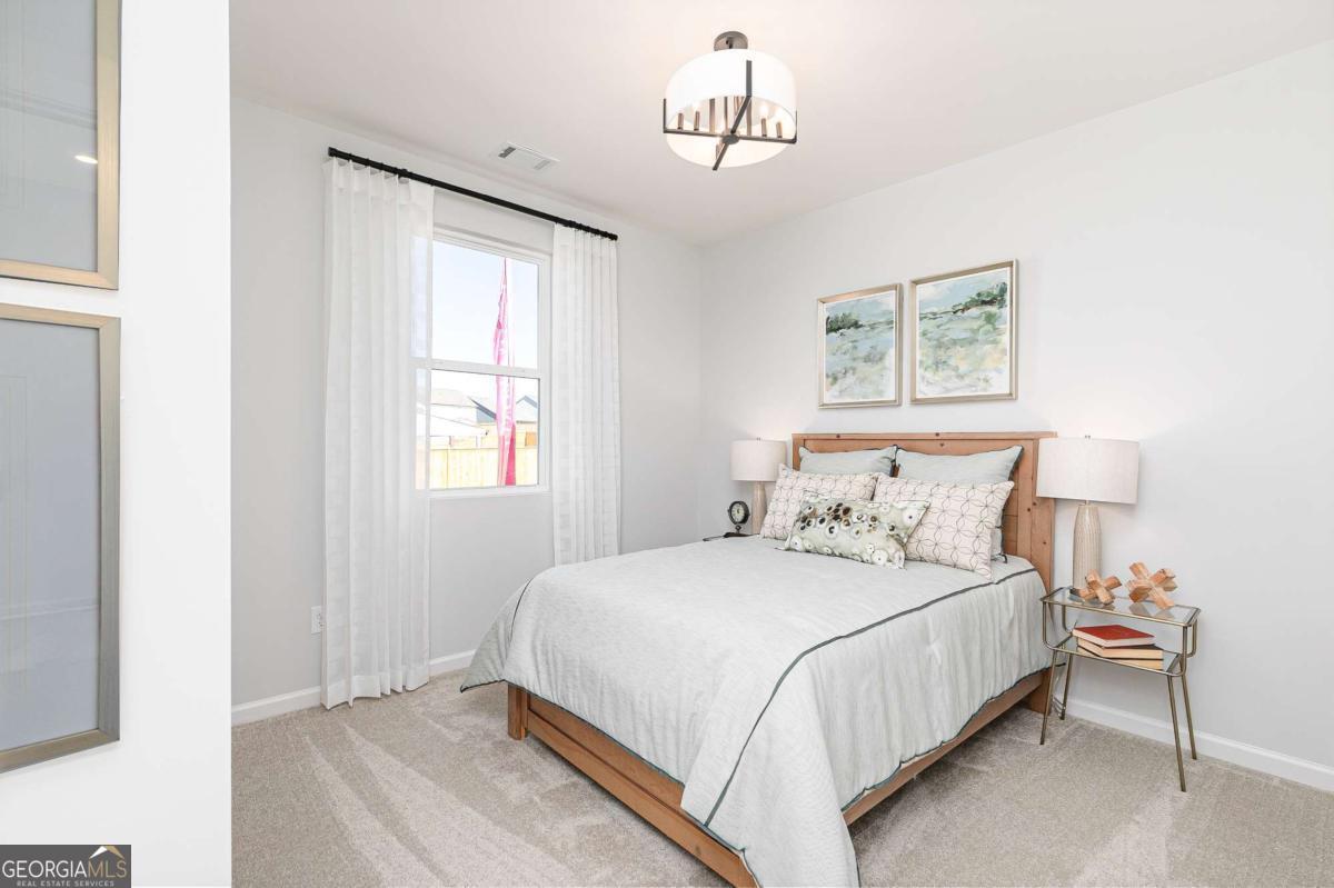 740 Coventry Cv Way Acworth, GA 30102 - Photo 6 of 41 a bedroom with a bed and a window