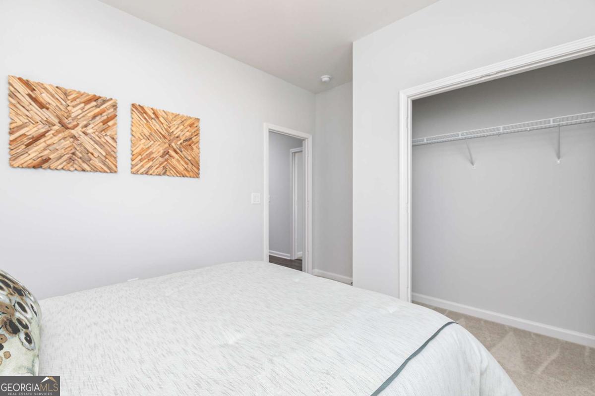 740 Coventry Cv Way Acworth, GA 30102 - Photo 7 of 41 a bedroom with a bed and a painting on the wall