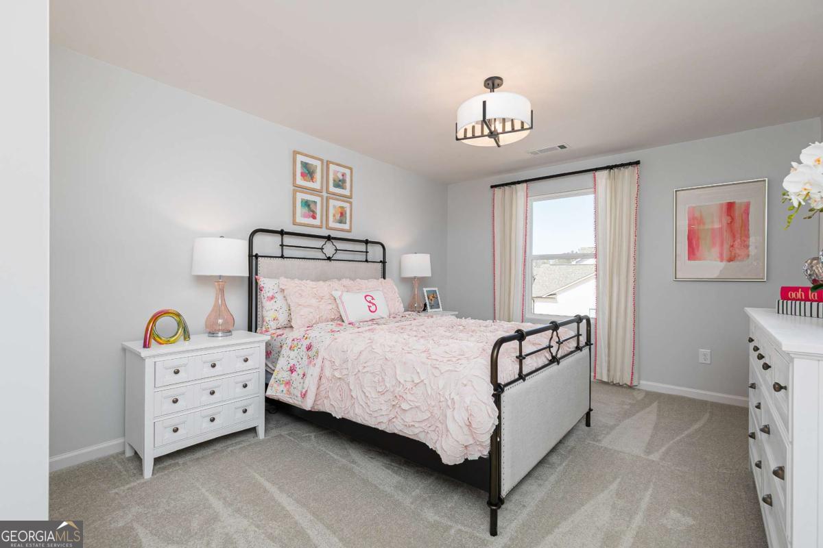 740 Coventry Cv Way Acworth, GA 30102 - Photo 8 of 41 a bedroom with a bed and a chandelier