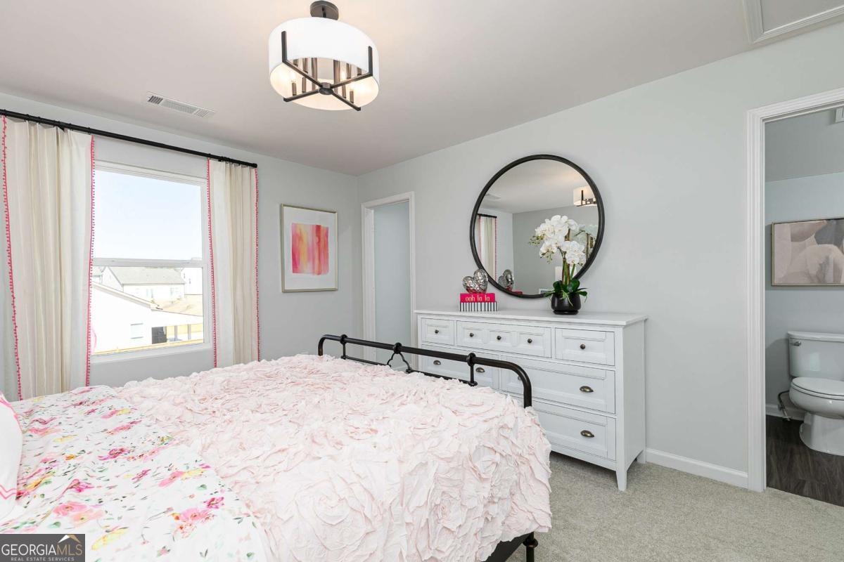 740 Coventry Cv Way Acworth, GA 30102 - Photo 9 of 41 a bedroom with a bed and a chandelier