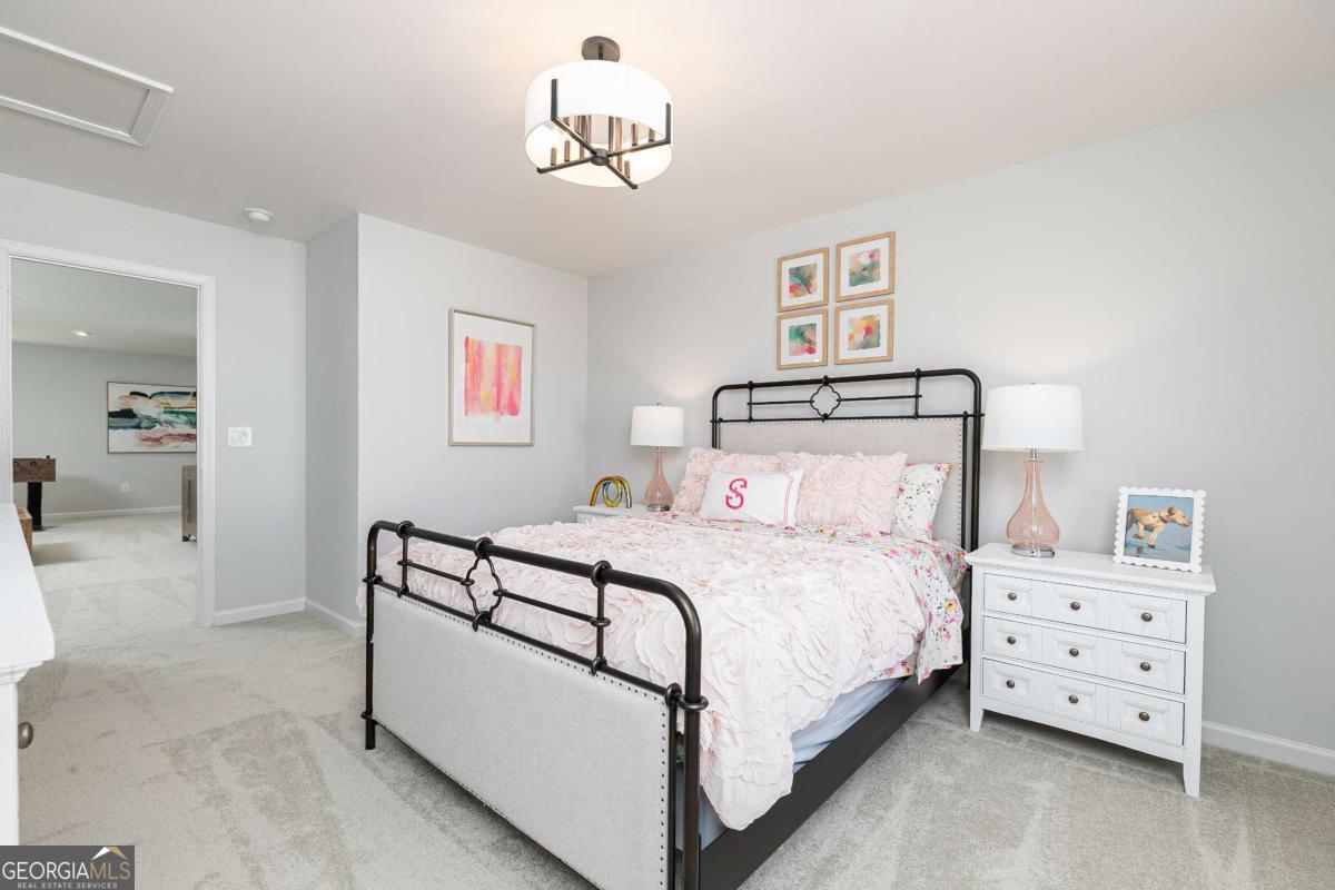 740 Coventry Cv Way Acworth, GA 30102 - Photo 10 of 41 a bedroom with a bed and a chandelier