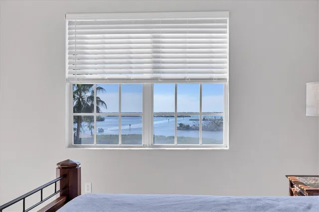 a sign that is sitting in front of a house with a big yard