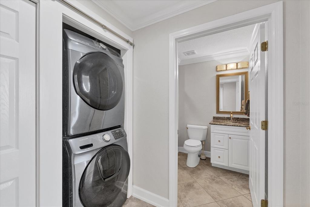 13313 Gasparilla Road, Unit C401 Placida, FL 33946 - Photo 22 of 30 a view of a hallway with washer and dryer