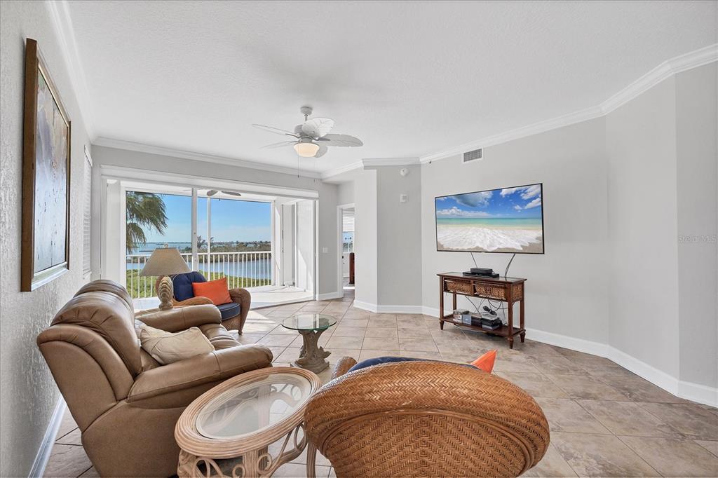 13313 Gasparilla Road, Unit C401 Placida, FL 33946 - Photo 3 of 30 a living room with furniture ceiling fan and a rug