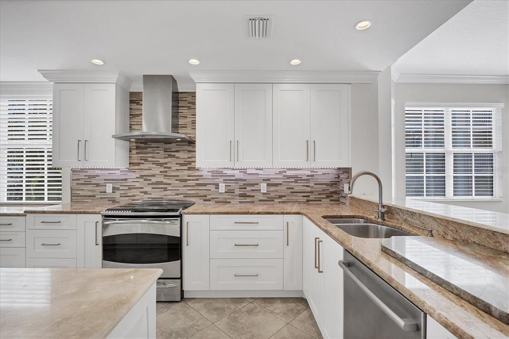 13313 Gasparilla Road, Unit C401 Placida, FL 33946 - Photo 10 of 30 a kitchen that has a sink and a stove