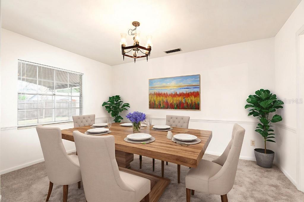 2453 Worthington Road Maitland, FL 32751 - Photo 13 of 22 a dining room with furniture potted plants and wooden floor