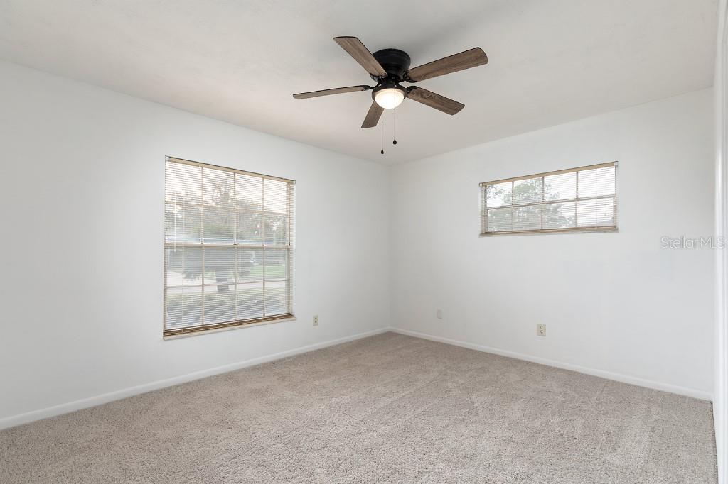 2453 Worthington Road Maitland, FL 32751 - Photo 19 of 22 an empty room with windows and fan