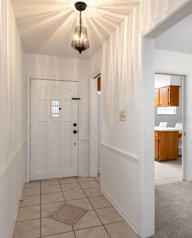 2453 Worthington Road Maitland, FL 32751 - Photo 4 of 22 a view of a hallway with a chandelier