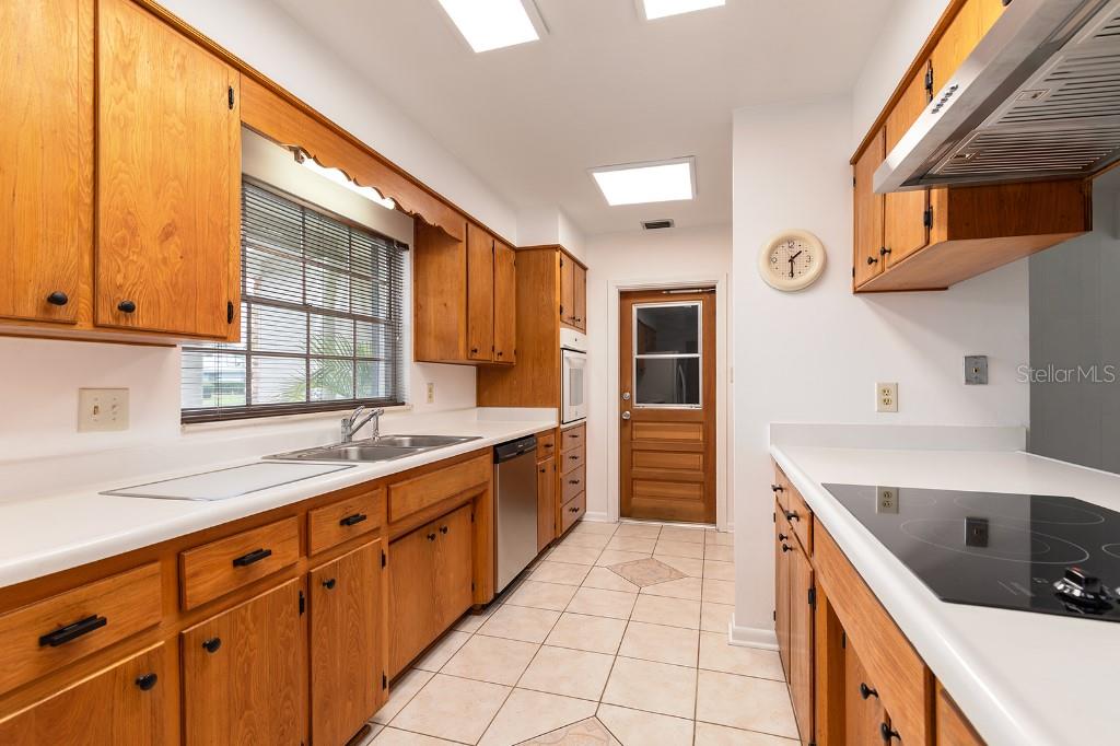 2453 Worthington Road Maitland, FL 32751 - Photo 6 of 22 a kitchen with stainless steel appliances sink cabinets and window