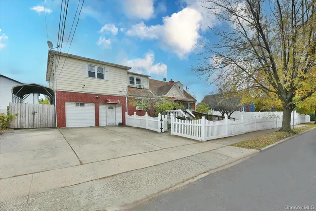 a view of a house with a yard and garage