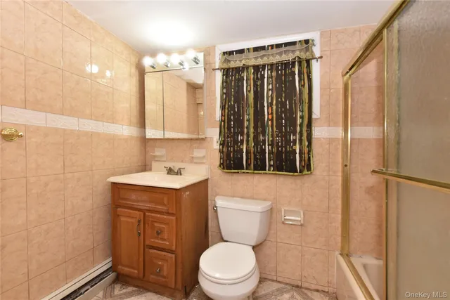 a bathroom with a toilet a sink and a shower