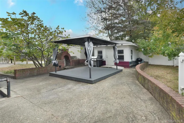 a view of a house with a yard and sitting area
