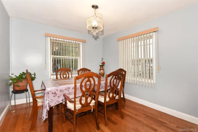 a view of a dining room with furniture wooden floor and a chandelier