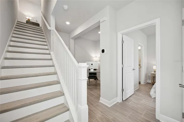 a view of a hallway with wooden floor and entryway