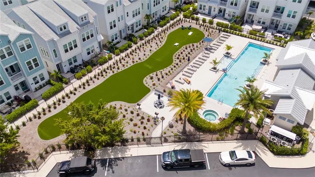 an aerial view of a swimming pool patio and outdoor seating
