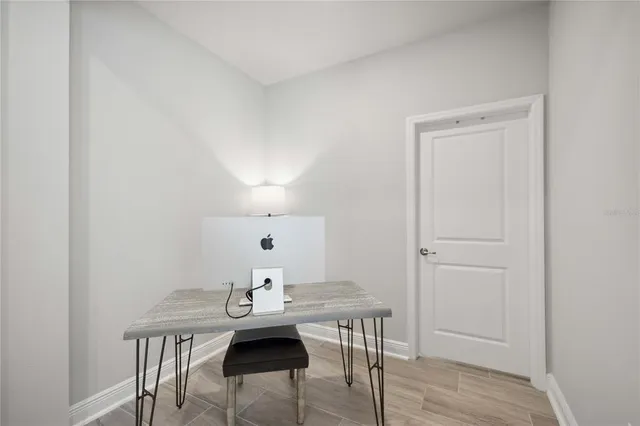 a view of a room with furniture and wooden floor