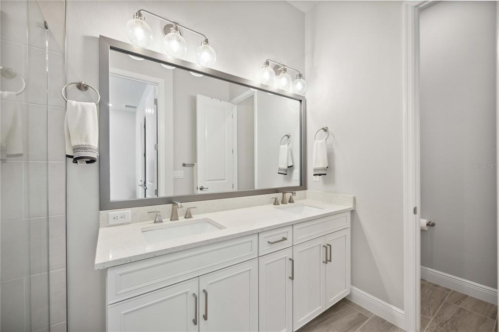 2344 Lindstrom Street Sarasota, FL 34237 - Photo 33 of 56 a bathroom with double sink and a mirror