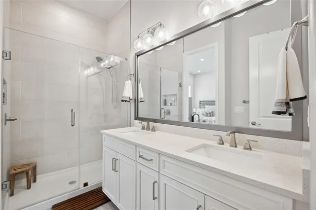 a bathroom with a sink a toilet and mirror