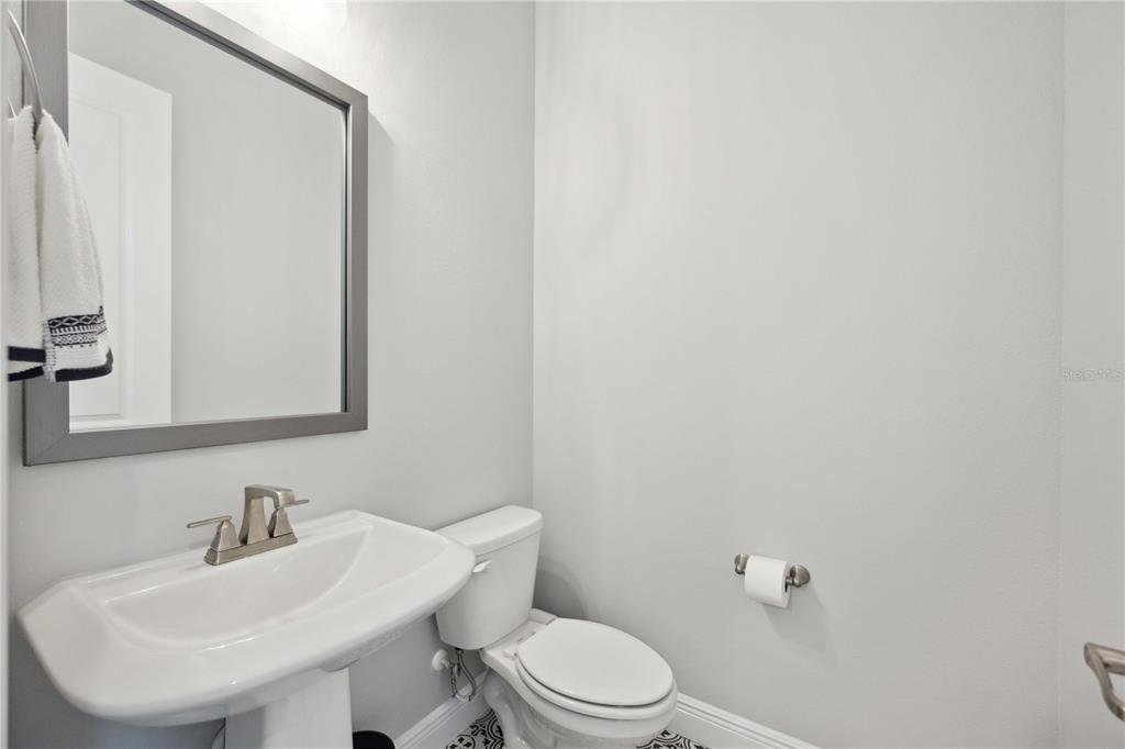 2344 Lindstrom Street Sarasota, FL 34237 - Photo 35 of 56 a bathroom with a sink a toilet and mirror