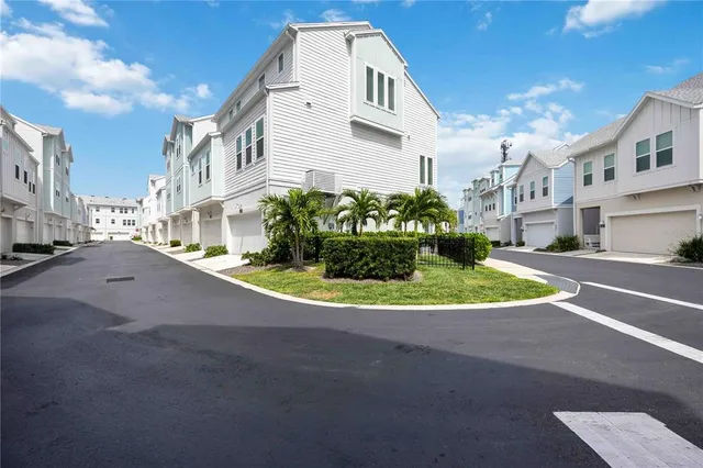 a view of a white house with a street