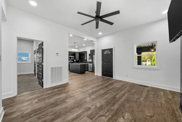 a view of a kitchen with a sink and a refrigerator
