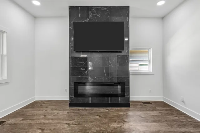 a living room with a fireplace and a flat screen tv