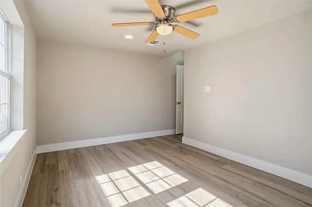 wooden floor in an empty room with a window