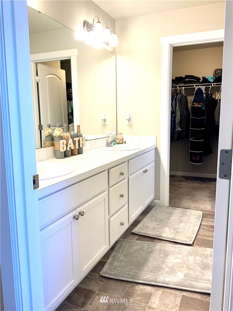 5107 Kenrick Street Southeast Lacey, WA 98503 - Photo 17 of 31 a bathroom with a double vanity sink and a mirror