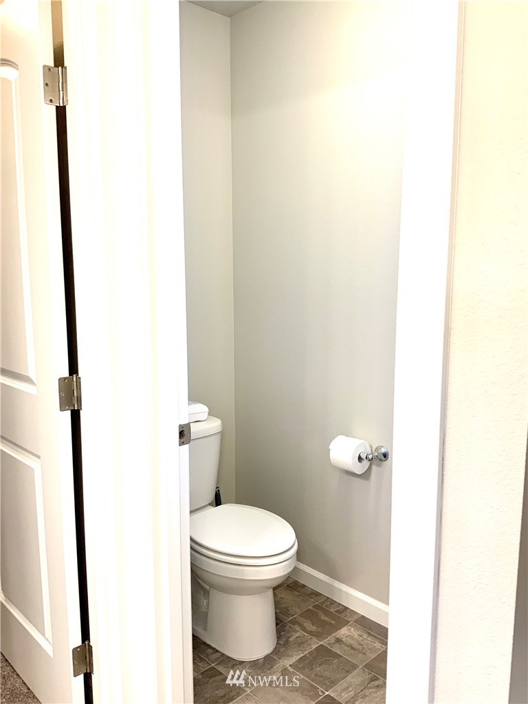 5107 Kenrick Street Southeast Lacey, WA 98503 - Photo 18 of 31 a white toilet sitting next to a shower