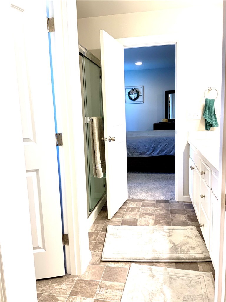 5107 Kenrick Street Southeast Lacey, WA 98503 - Photo 19 of 31 a en suite bathroom with a sink and a mirror