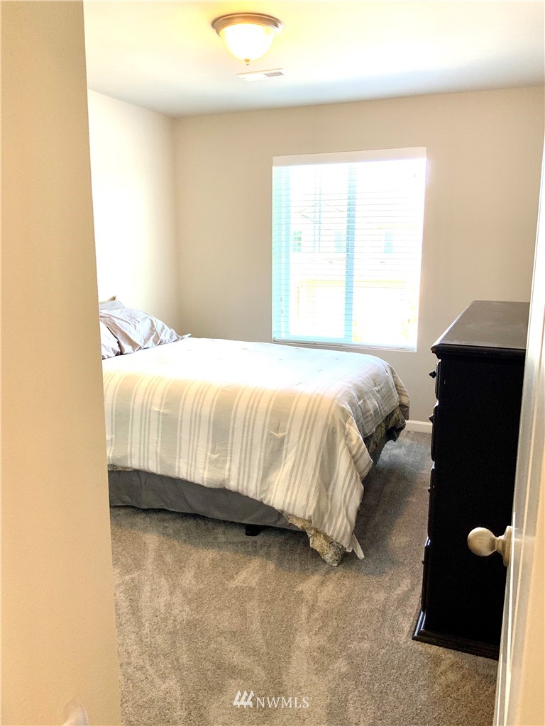 5107 Kenrick Street Southeast Lacey, WA 98503 - Photo 20 of 31 a bedroom with a bed and a window