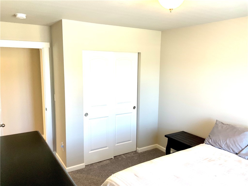 5107 Kenrick Street Southeast Lacey, WA 98503 - Photo 21 of 31 a bedroom with a bed and a cabinet