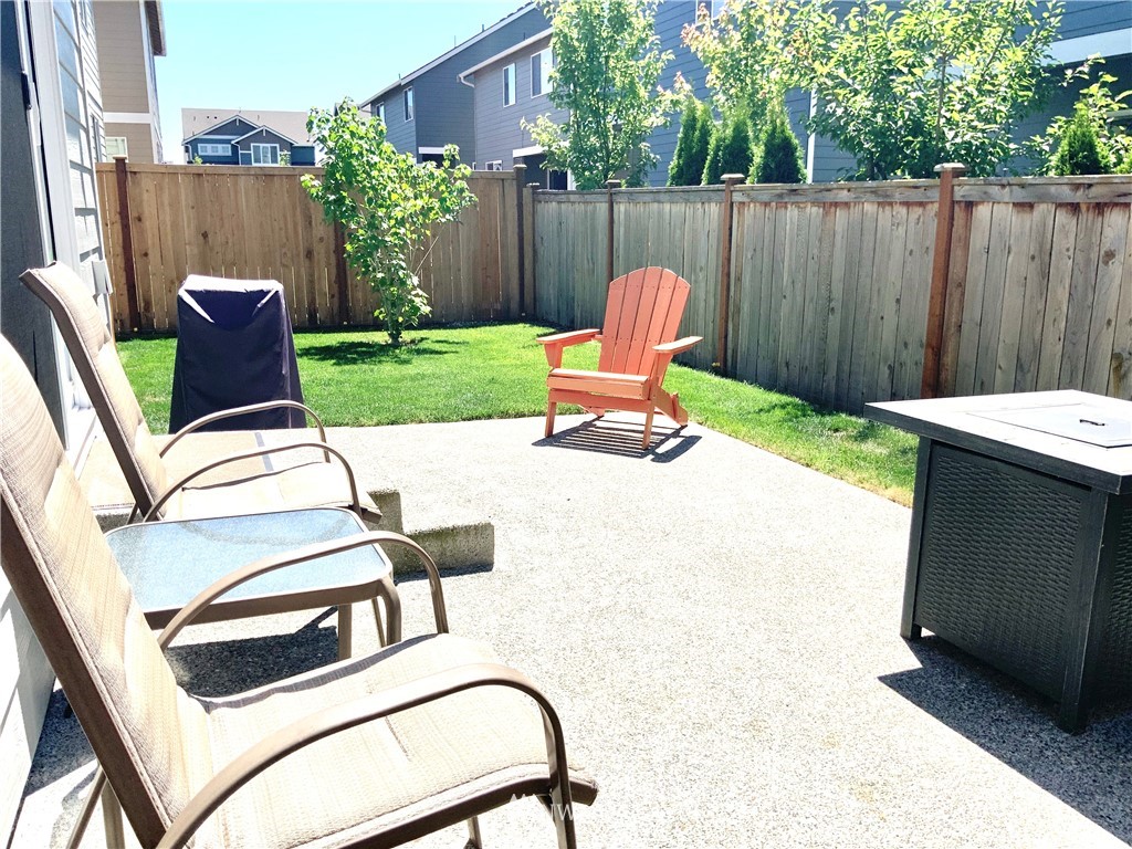5107 Kenrick Street Southeast Lacey, WA 98503 - Photo 31 of 31 a backyard of a house with yard fire pit and furniture